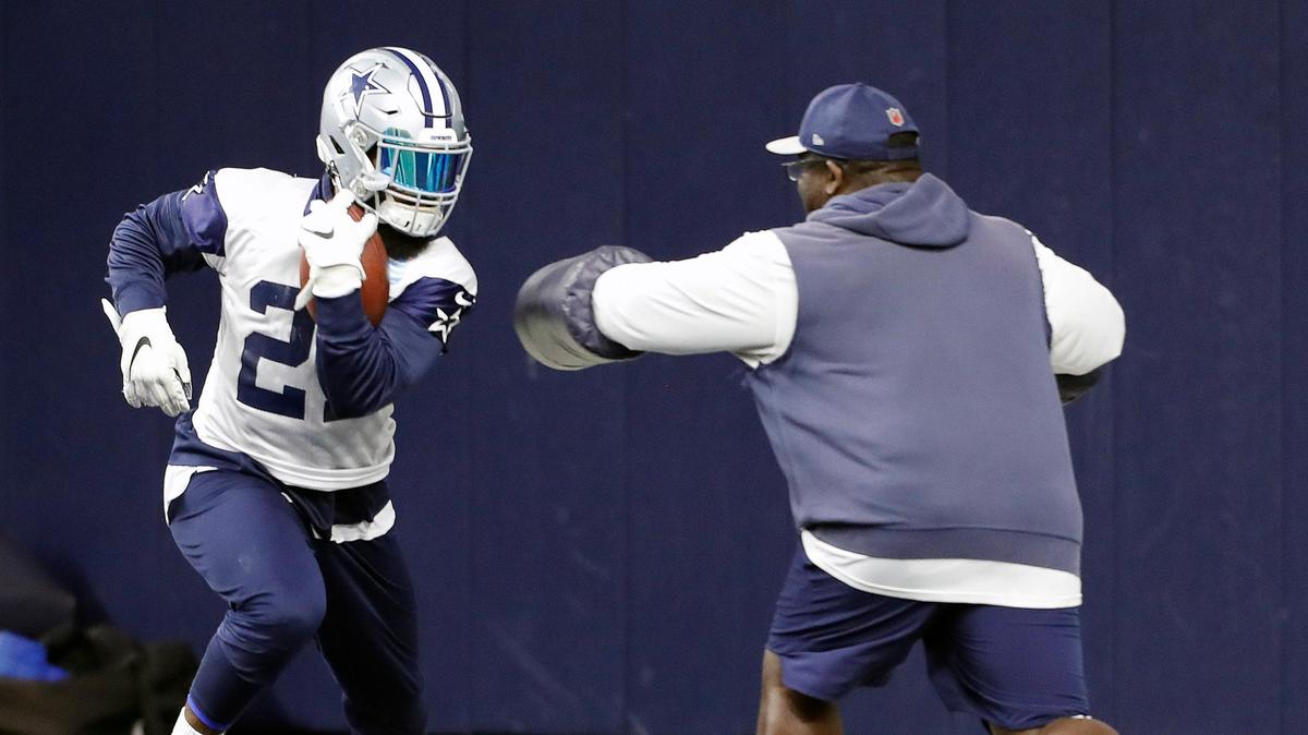 Running backs coach Gary Brown puts running back Ezekiel Elliott (21) through drills during the Dallas Cowboys OTA’s at The Star in Frisco, Wednesday, May, 29, 2019. (Special to the Star-Telegram Bob Booth)