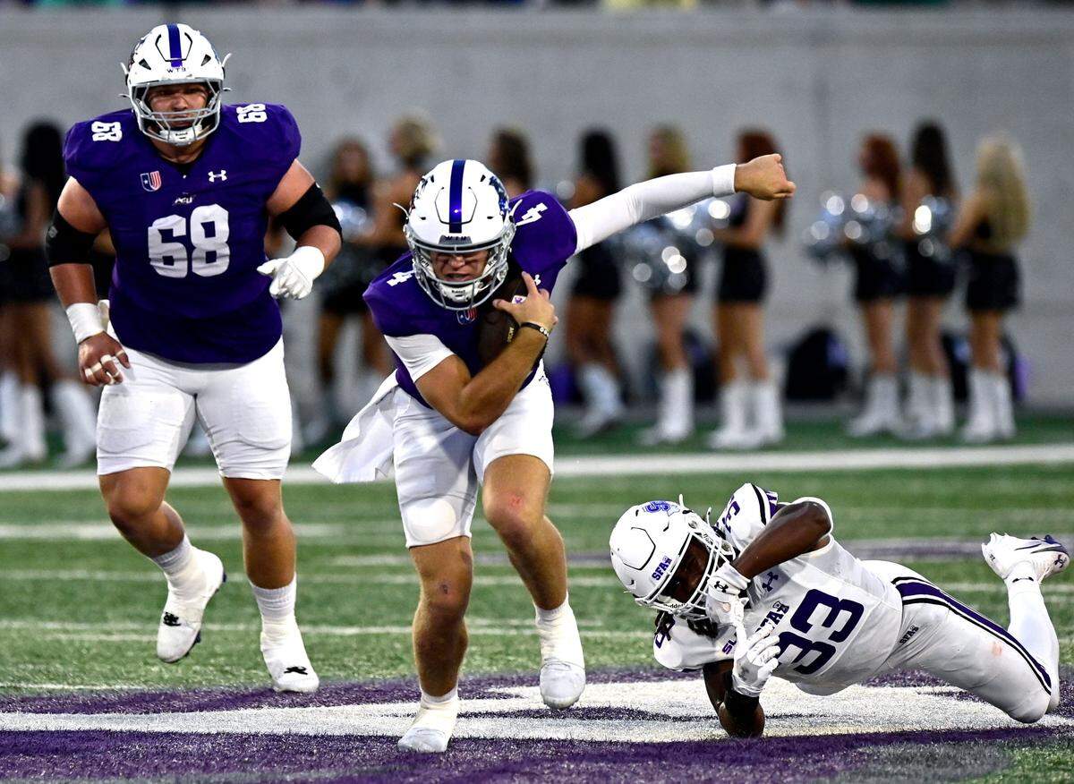 ACU quarterback Stone Earle (center) slips from SFA linebacker Malachi Williams' attempt at a tackle as Wildcats offensive lineman Colter Lynch runs to assist Saturday Sept. 6, 2025. Abilene Christian University defeated Stephen F. Austin University at home, 28-20.