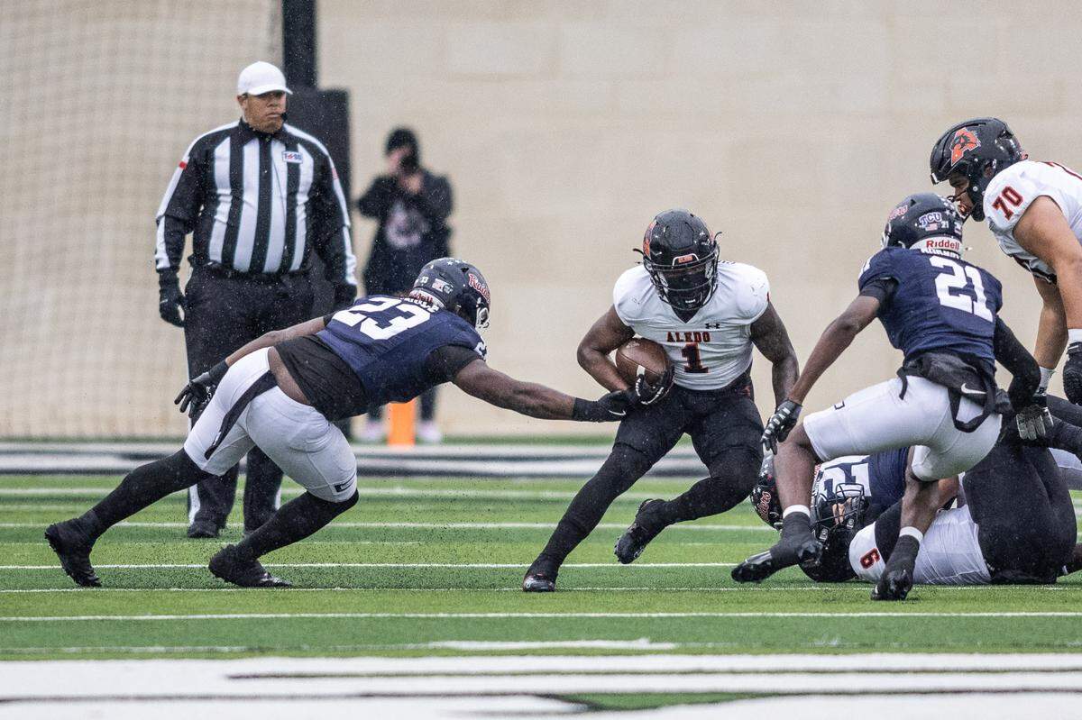 Aledo’s Raycine Guillory, Jr. (1) looks for room to run against Denton Ryan in a Class 5A Division 1 state quarterfinal on Saturday, Dec. 7, 2024 at Crowley ISD Multi-Purpose Stadium in Fort Worth, Texas.