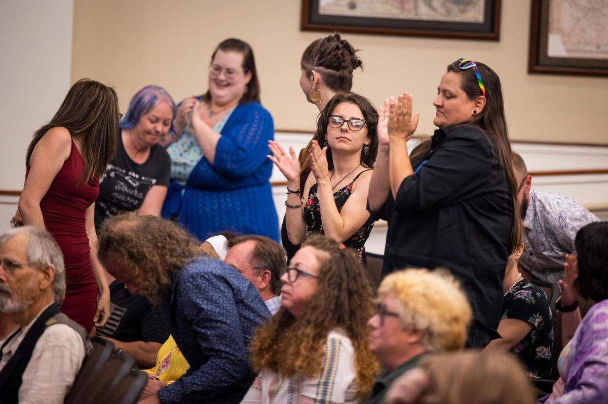 LGBTQ supporters clap after a speaker during public comment of the City Council meeting Monday in Watauga.