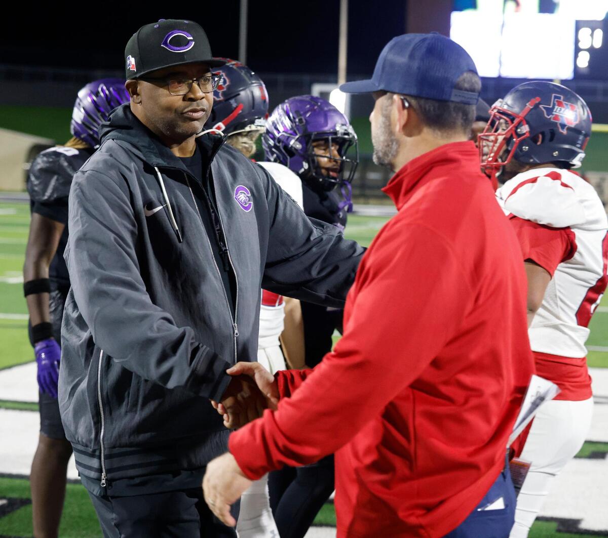 Crowley head coach Carlos Lynn and Northwest head coach Bill Poe meet at mid field after a UIL Class 6A D2 Bi-district playoff football game at Crowley ISD Multi-Purpose Stadium in Fort Worth, Texas, Friday, Nov. 15, 2024.
