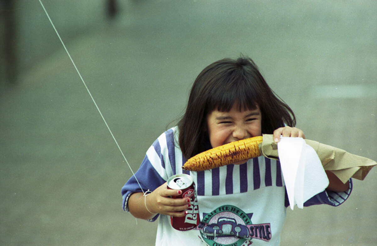 Sept. 7, 1990: Erin Garcia, 8, munches on an ear of corn during the Mexican Independence Day festivities during the 12th annual Fiesta-In-The-Park in Fort Worth.