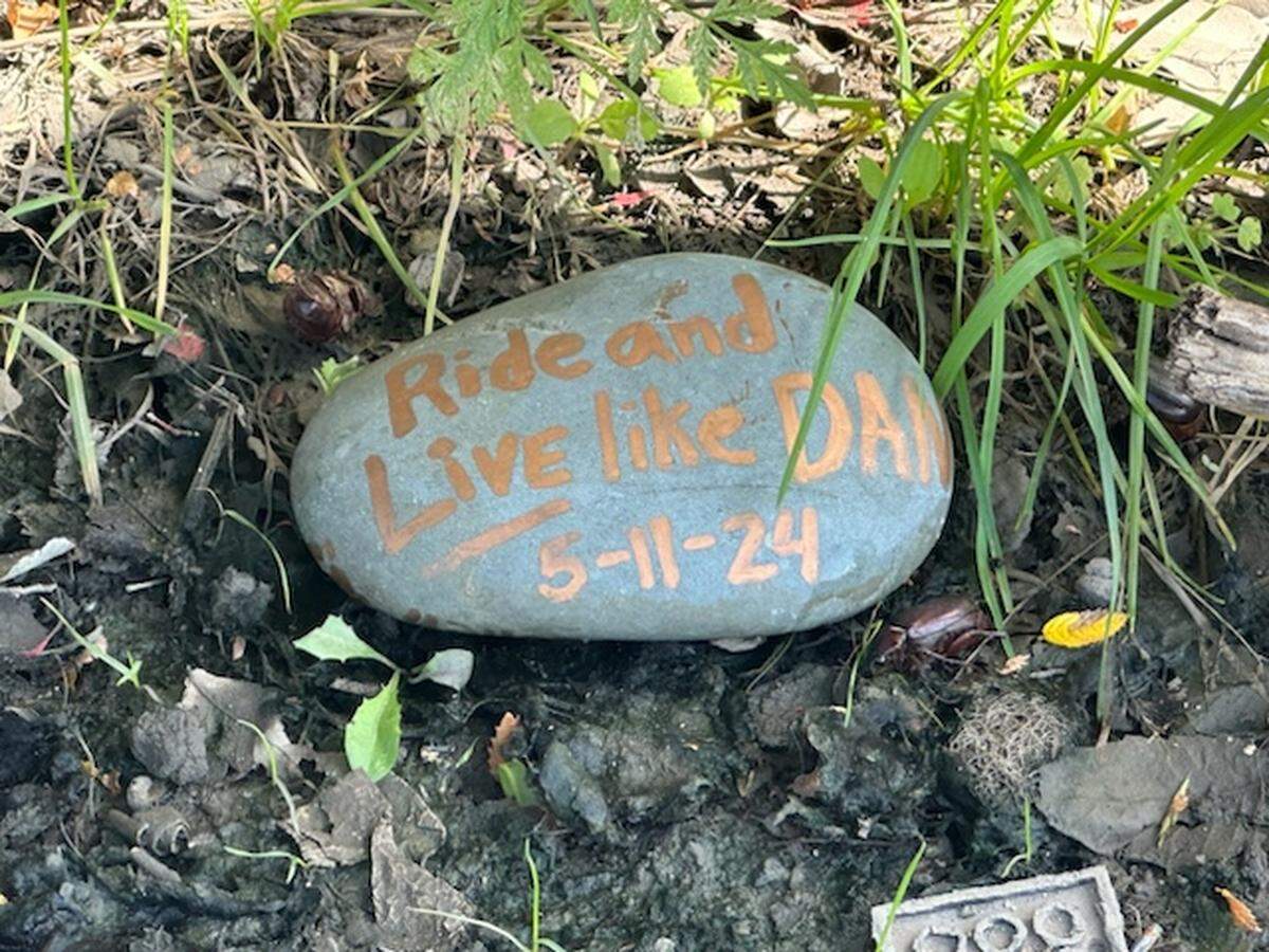 About 20 members of Dan Frost’s cycling group rode out to the small community of Lillian, one of Frost’s favorite biking destinations, on May 18 to leave a memorial rock with his name and date of death.