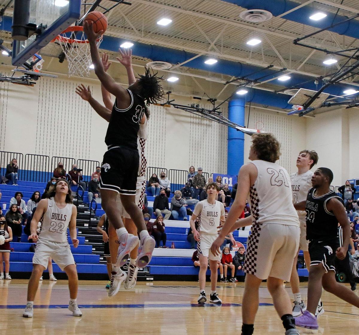 YMLA’s Monterrio Golightly (30) lays in a left hander for two during a 4A Region 1 bi-district basketball game at Brewer High School in Fort Worth, Texas, Monday, Feb. 22, 2021. YMLA defeated Bridgeport 67-60 in overtime. (Special to the Star-Telegram Bob Booth)