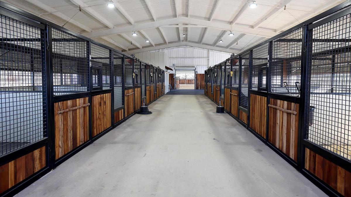 This Weatherford property features a barn with 12 stalls, as well as a covered arena with holding pens on each corner.