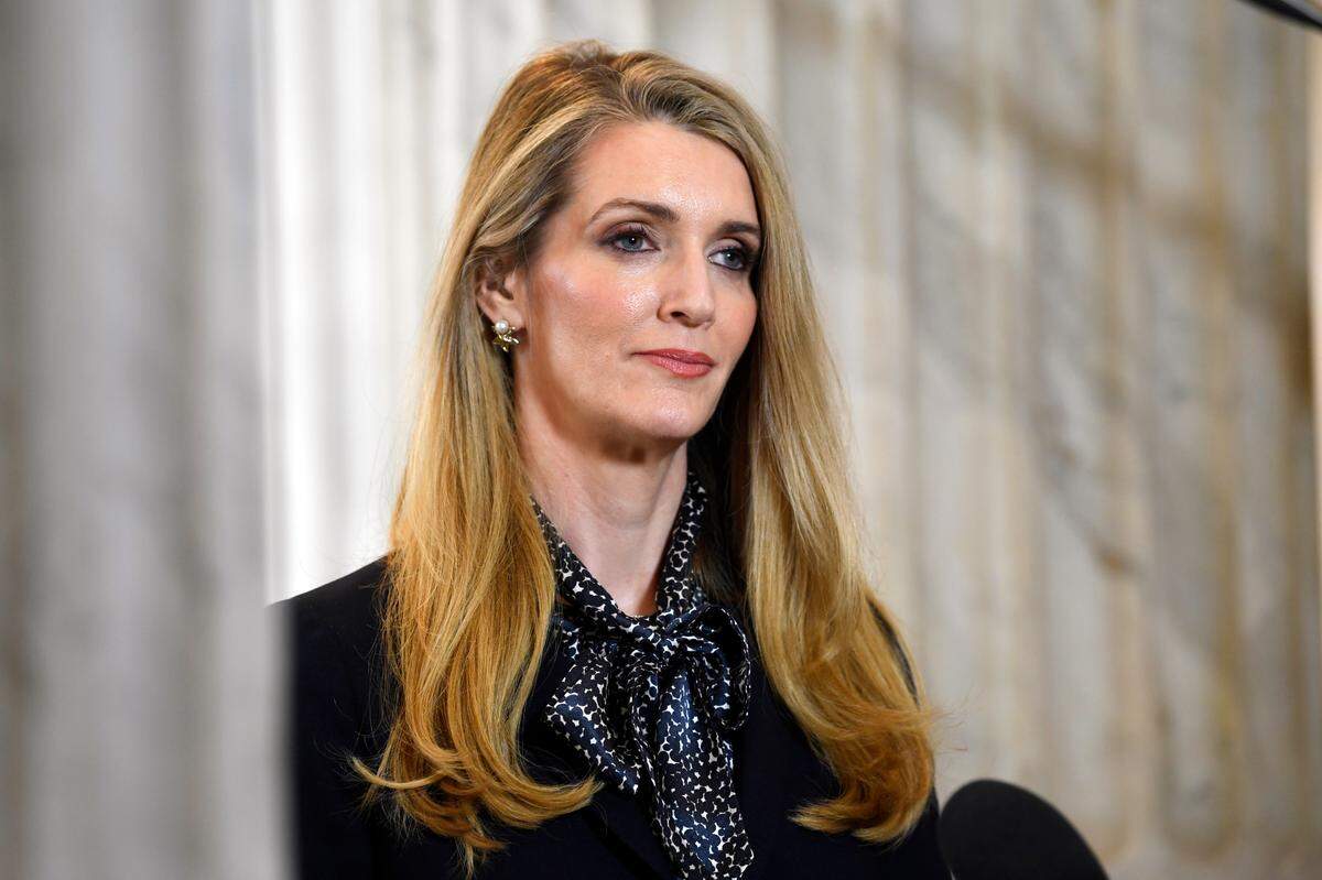 FILE - In this Friday, March 20, 2020, file photo, Sen. Kelly Loeffler, R-Georgia, waits to speak in a television interview on Capitol Hill in Washington. WNBA players have urged people to vote against Atlanta Dream co-owner Loeffler, a Republican U.S. senator running to keep her seat in Georgia. Loeffler, who spoke out publicly against the league’s social justice plans and sent a letter to WNBA Commissioner Cathy Engelbert objecting to the initiatives to honor the Black Lives Matter movement once the season began last month, is facing opposition from Raphael Warnock. (AP Photo/Susan Walsh, File)