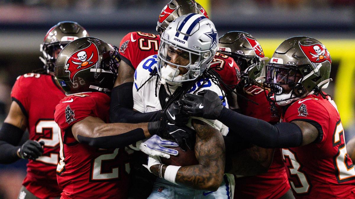 Cowboys wide receiver CeeDee Lamb (88) is stopped by multiple Buccaneers defenders in the first half of an NFL game between the Dallas Cowboys and the Tampa Bay Buccaneers at AT&T Stadium in Arlington on Sunday, Dec. 22, 2024.