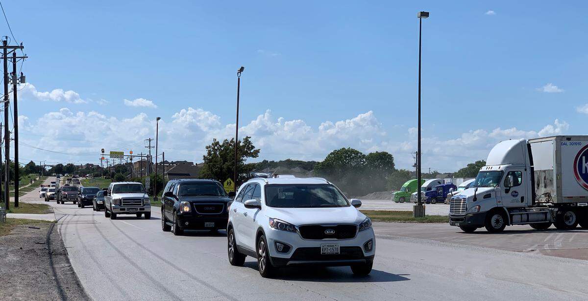 A truck driver waits for a chance to turn left on Kroger Drive, near Keller Central High School in far north Fort Worth, where city officials recently opted not to build two roundabouts.