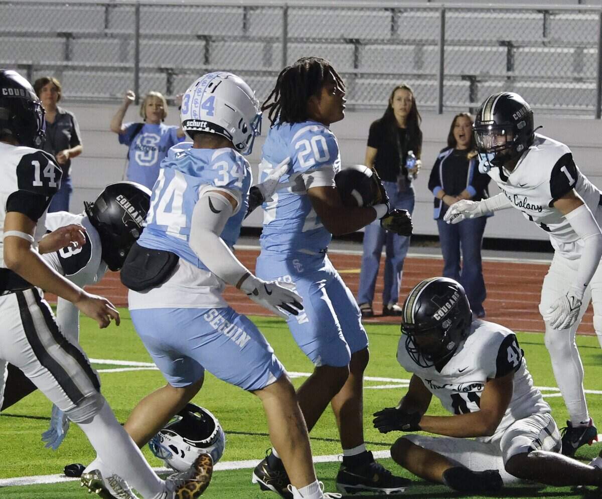 Arlington Seguin running back Isaac Bly (20) has his helmet removed as he scores for the Cougars during the first half of a UIL football game between The Colony and Arlington Seguin at Glaspie Field in Arlington, Texas, Thursday, Sept. 25, 2025.
