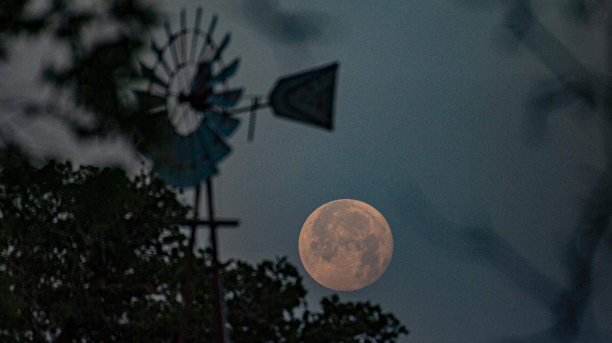 A full moon setting over a ranch in North Texas.