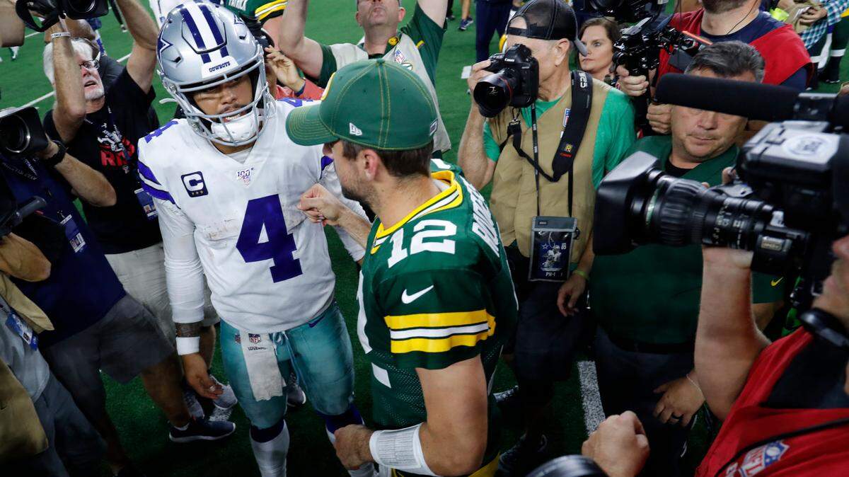 Dallas Cowboys quarterback Dak Prescott (4) and Green Bay Packers quarterback Aaron Rodgers (12) greet each other on the field after an NFL football game in Arlington on Oct. 6, 2019.