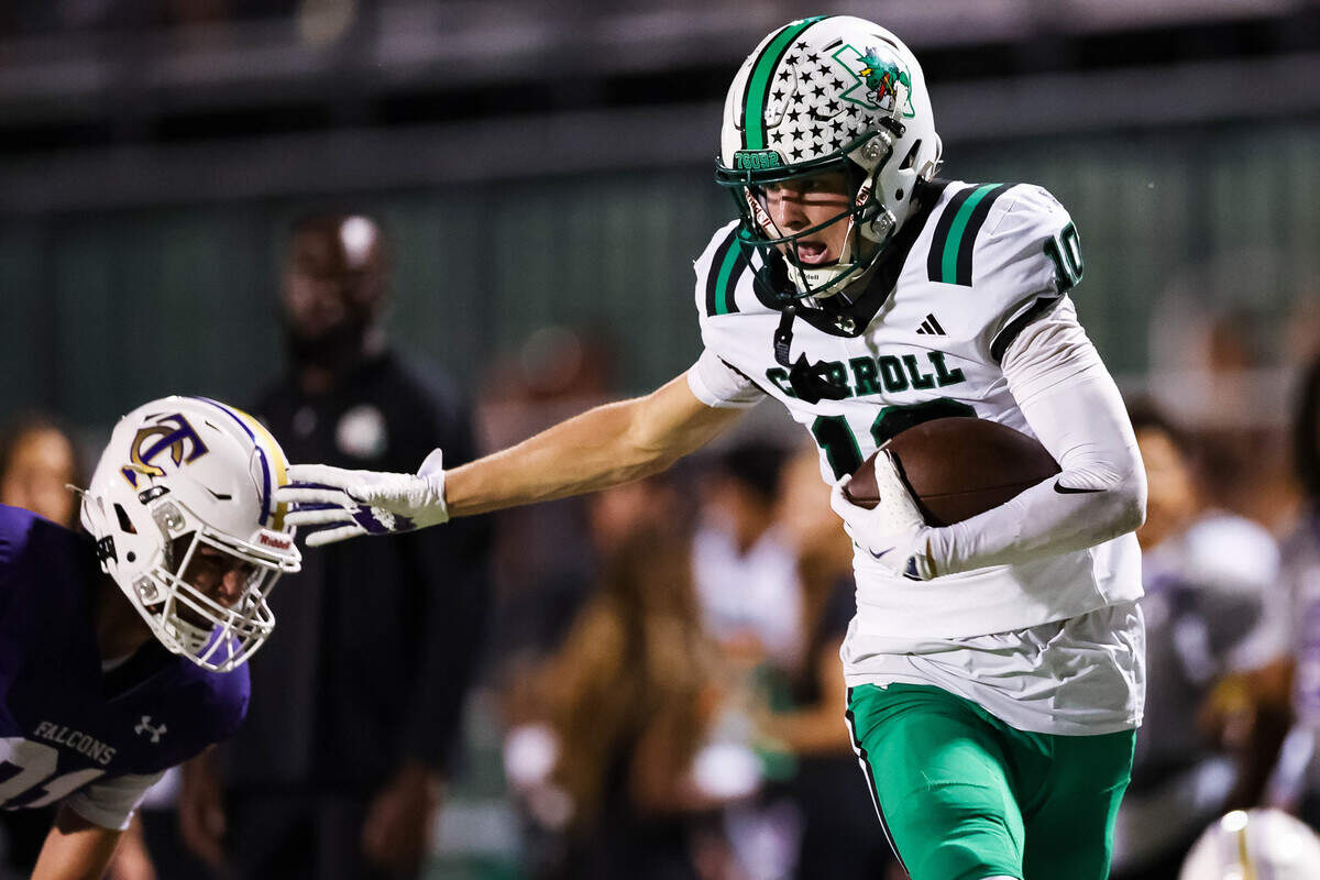 Southlake Carroll wide receiver Brody Knowles (10) runs with the ball and stiff arms a Keller Timber Creek defender during a district matchup on Thursday, September 25, 2025 at Keller ISD Stadium in Keller, Texas.