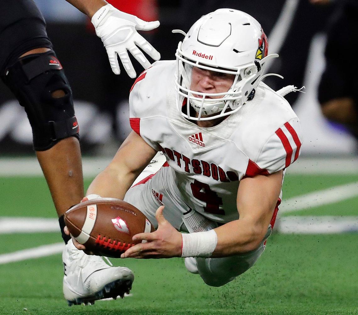 Pottsboro quarterback Braden Plyler (4) goes down in the backfield attempting to shovel the ball during the fourth quarter of a conference 3A division I State Championship football game at AT&T in Arlington, Texas, Thursday, Dec. 19, 2019. Grandview defeated Pottsboro 42-28. (Special to the Star-Telegram Bob Booth)