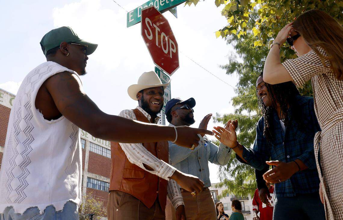 Leon Bridges, center, takes photographs with family, friends and fans after attending the ceremonial street naming in his honor on Tuesday, Oct. 7, 2025, at the corner of South Calhoun Street and East Daggett Avenue in Fort Worth. Bridges, a Grammy-winning artist and native of Fort Worth, recorded his debut album at Niles City Sound, located across the street from the sign topper.