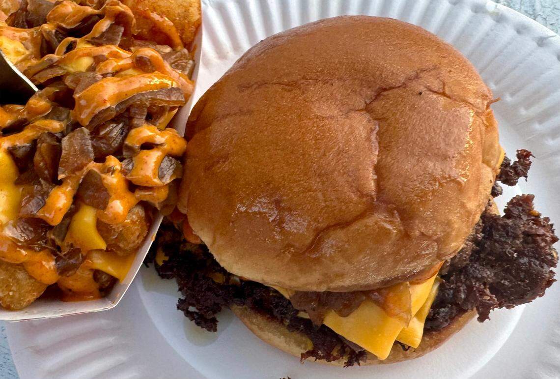 A Gustos burger with caramelized onions, pickles and sauce, with Gustos tots topped with caramelized onions and sauce at Gustos Burger Bar in Fort Worth.