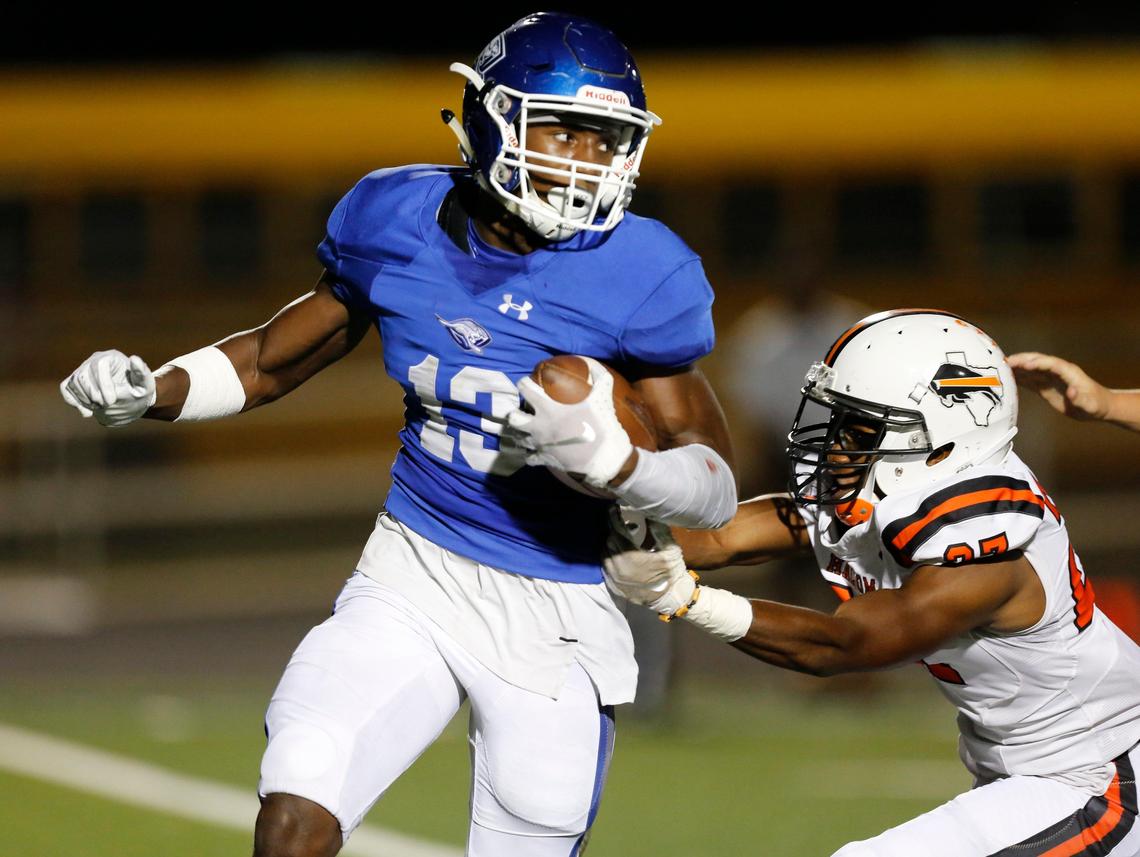 WeatherfordÕs Cicero Caston (13) carries in the first quarter, pursued by HaltomÕs Eric Delgadillo (83). The Haltom Buffalos played the Weatherford Kangaroos at Kangaroo Stadium in Weatherford Thursday, Oct. 3, 2019.