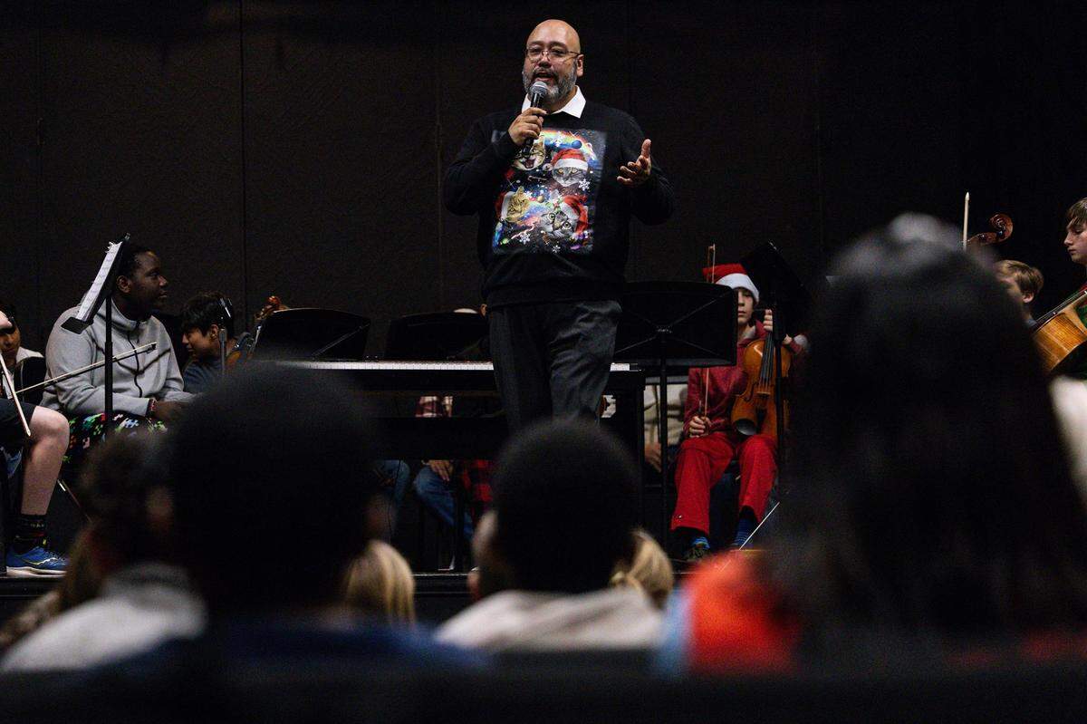 Orchestra director Julio Montañez speaks to students from Ridglea Elementary School during their visit at Applied Learning Academy in Fort Worth on Thursday.