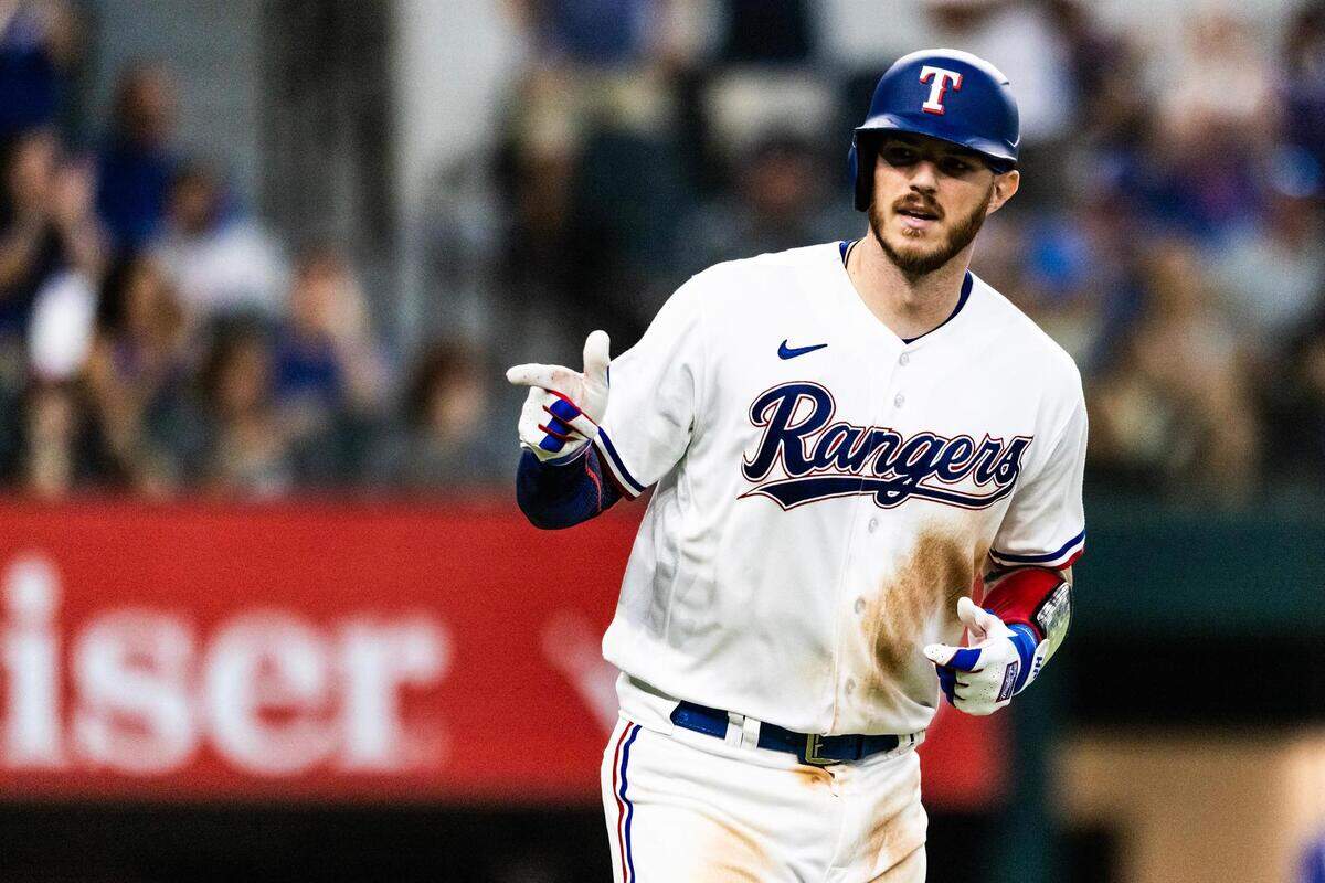 Texas Rangers catcher Jonah Heim (28) points to the dugout after hitting a three-run home run in the eighth inning of a regular season game against the Tampa Bay Rays at Globe Life Field in Arlington, Texas on Wednesday, July 19, 2023.