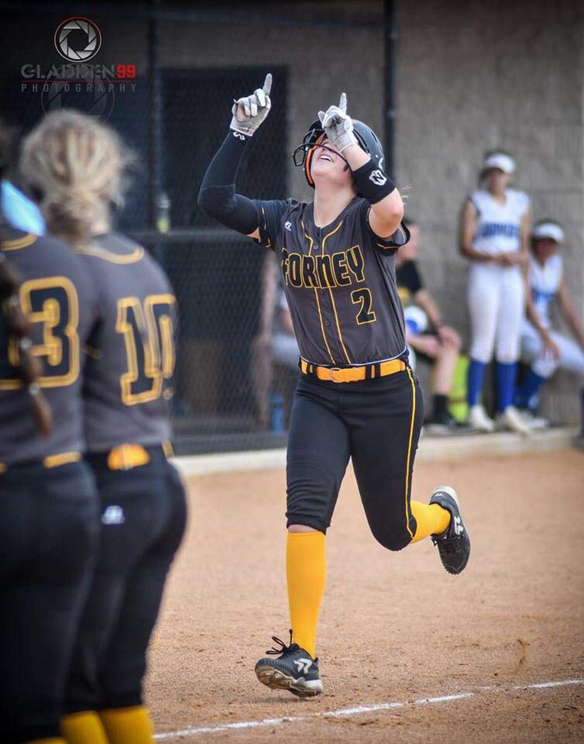 Forney sophomore Savanna DesRochers points to the sky for teammate Emily Galiano after hitting a home run during a recent softball game in 2018.