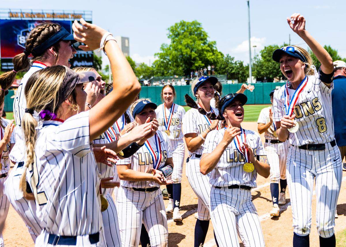 The Montgomery Lake Creek softball team celebrates with their medals after winning the Class 5A state championship over New Braunfels Canyon on Saturday, June 3, 2023, at McCombs Field in Austin, TX.