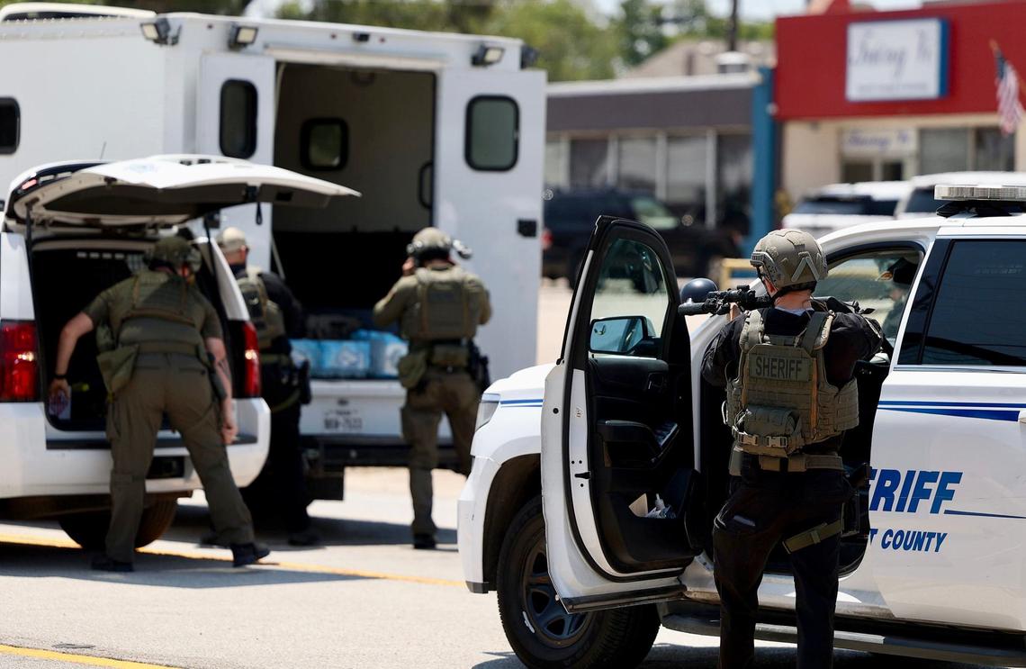 Law enforcement, including a SWAT team, responds to an active scene near North Beach Street where a sheriff’s deputy was shot Wednesday afternoon in Fort Worth.