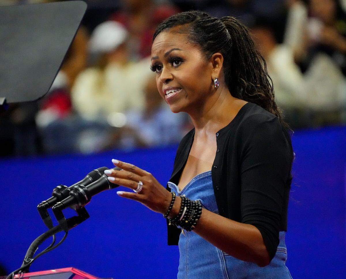 Former First Lady Michelle Obama greets the crowd on day one of the 2023 U.S. Open tennis tournament at USTA Billie Jean King National Tennis Center.