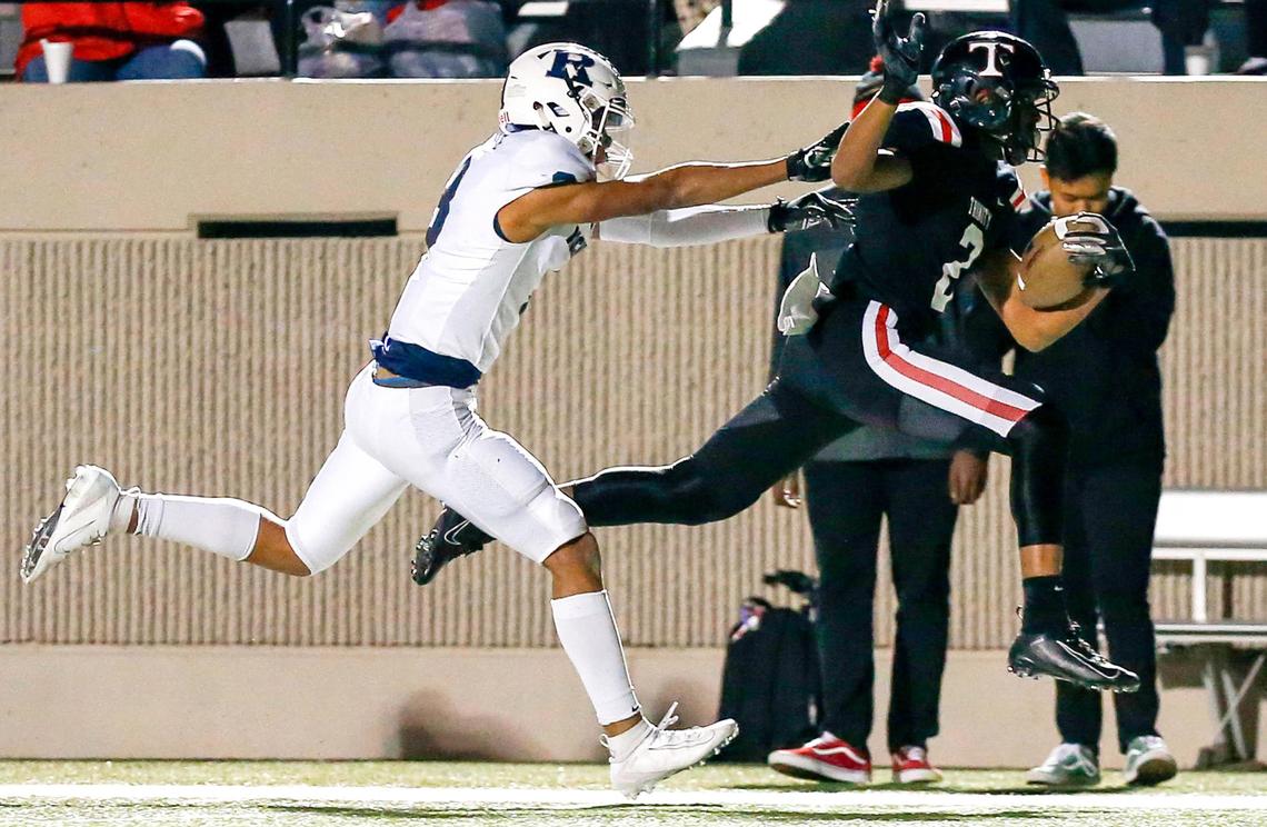 Euless Trinity running back Ollie Gordon (2) gets pushed out of bounds by Richland’s C.J. Baskerville (3) after a long run during the first half, Friday night, November 8 2019 played at Pennington Field in Bedford, TX.