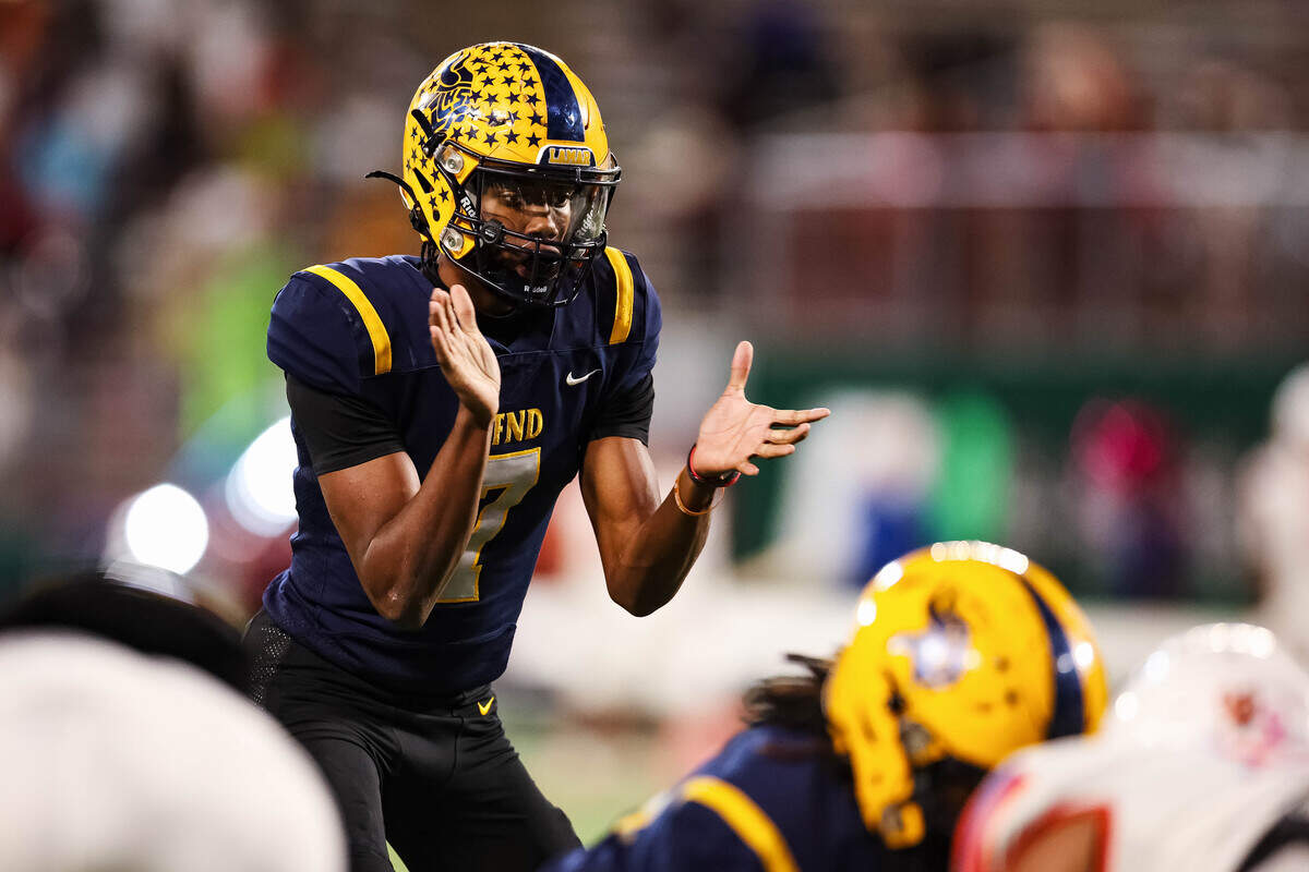 Arlington Lamar quarterback Jayden Shaw (7) claps and yells for the center to snap the ball in a district match up against Arlington Bowie at Choctaw Stadium in Arlington, Texas on October 30, 2025.