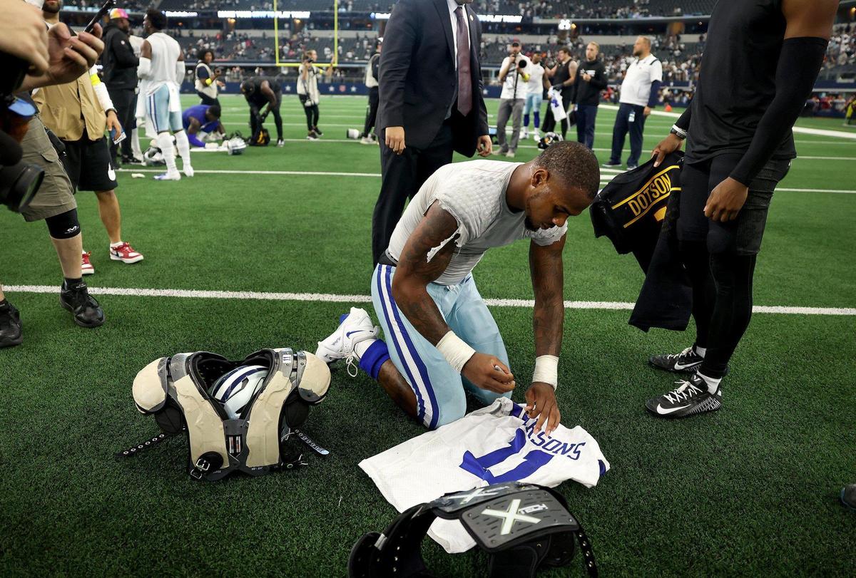 Dallas Cowboys’ Micah Parson signs his jersey following his team’s 25-10 win over the Washington Commanders on Sunday, October 2, 2022, at AT&T Stadium in Arlington.
