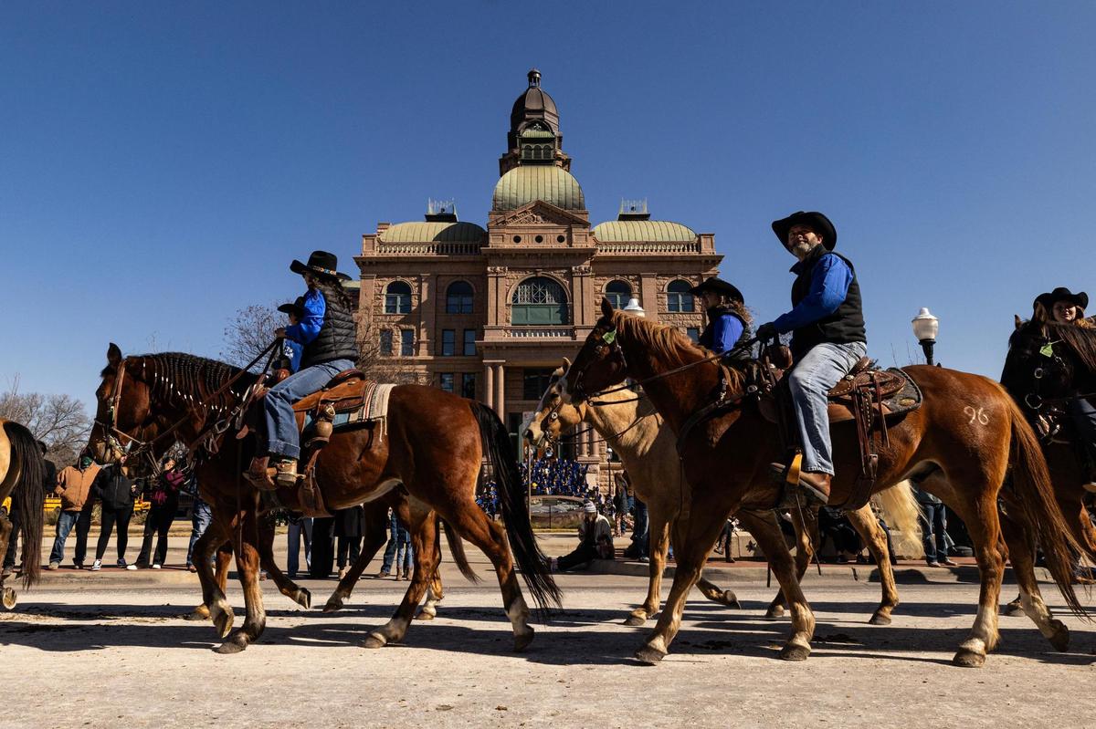 Members of the Stockyard Supply Company ride past the Tarrant County Courthouse on Houston Street for the Fort Worth Stock Show All Western Parade in downtown Fort Worth on Saturday, Jan. 18, 2025.