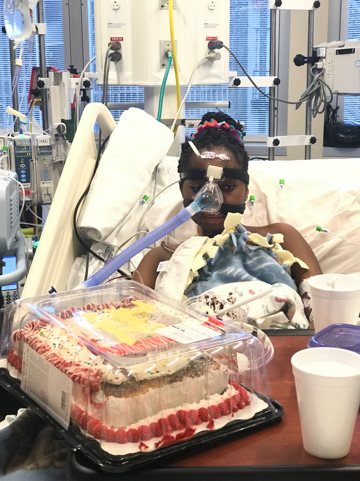 Dorika celebrates her 13th birthday in the hospital with her family and a cake.