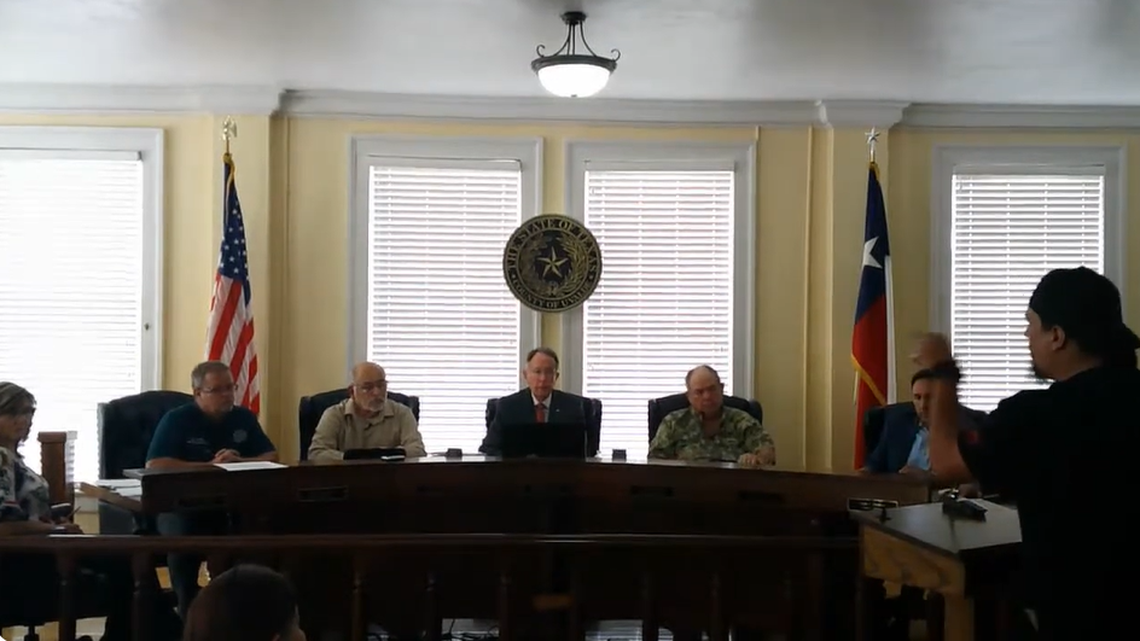 Brett Cross (right) speaks to Uvalde County Commissioners during a Feb. 26 meeting.