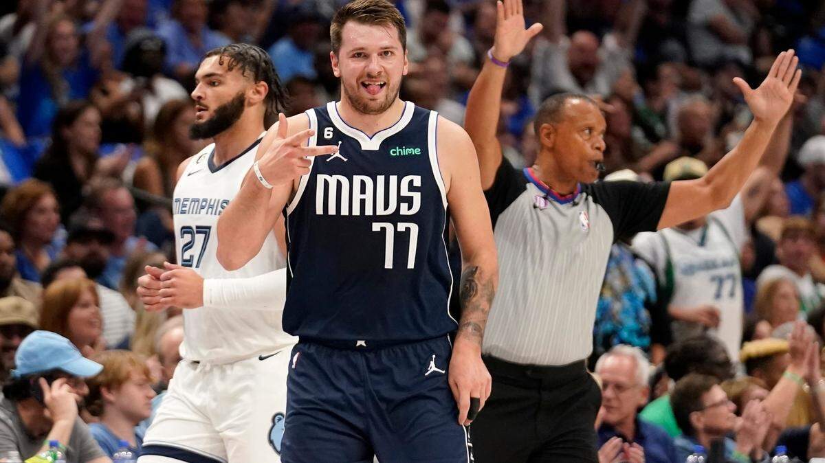 Dallas Mavericks guard Luka Doncic (77) celebrates sinking a 3-point basket, while Memphis Grizzlies guard David Roddy (27) walks past during the first half of an NBA basketball game in Dallas, Saturday, Oct. 22, 2022. (AP Photo/Tony Gutierrez)