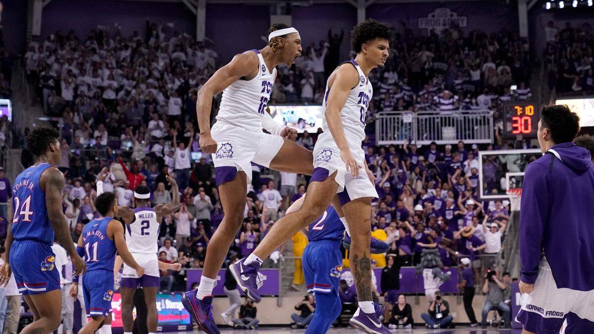 Kansas forward K.J. Adams (24) and Remy Martin (11) walk past as TCU forward Xavier Cork (12) and Micah Peavy (0) celebrate in the second half of an NCAA college basketball game in Fort Worth, Texas, Tuesday, March 1, 2022. Peavy scored 16 and Cork had 10 in TCU’s 79-66 win over Iowa in the Emerald Coast Classic on Nov. 26, 2022. (AP Photo/Tony Gutierrez)