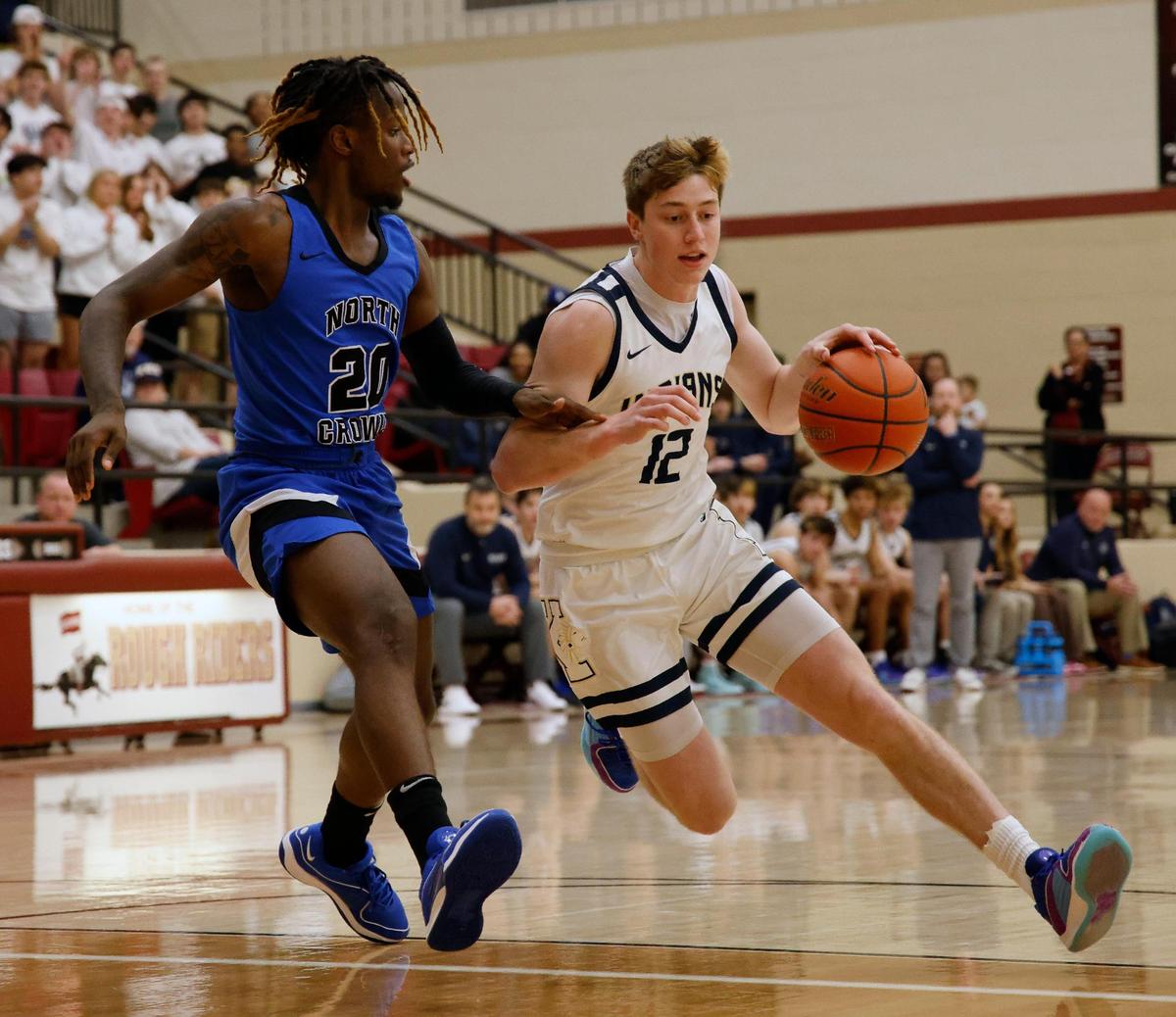 Keller shooting guard Rhett Schank (12) drives on North Crowley forward Justin McCray (20) during the first period of the Conference 6A Region 1 quarterfinals basketball playoffs at Saginaw High School in Saginaw, Texas, Tuesday, Feb. 27, 2024.