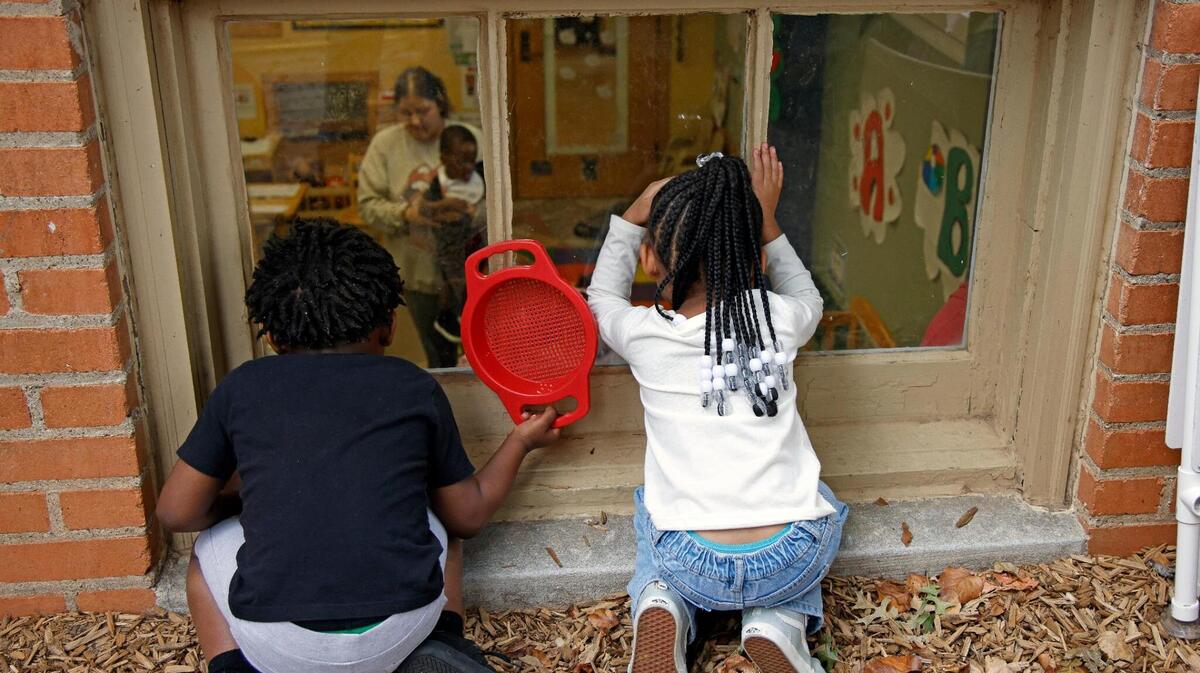 Children peek into a classroom during play time at the Rosie K. Mauk Child Development Center in Fort Worth. The Center for Transforming Lives announced a $38.5 million expansion on Monday.