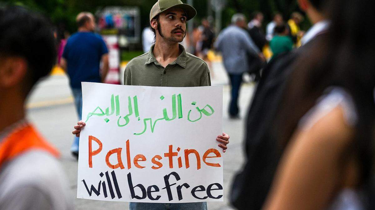 Jules Lattimore, a pro-Palestine demonstrator with the Students for a Democratic Society and Austin for Palestine Coalition, protests UT's relationship with weapon manufacturers that work with Israel at The University of Texas at Austin's commencement ceremony at Royal-Memorial Stadium on Saturday, May 11, 2024 in Austin.