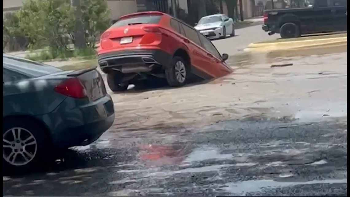 A Texas man drove his SUV over what he thought was a puddle, then quickly found out it was a sinkhole.