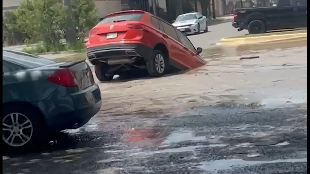 A Texas man drove his SUV over what he thought was a puddle, then quickly found out it was a sinkhole.