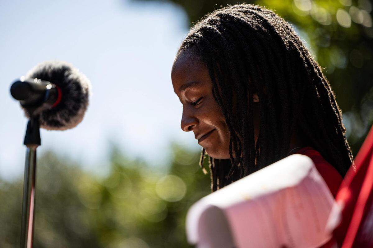 Jamere Thomas gives a speech during the Girls Inc. of Tarrant County 2023 Day of the Girl march event at Burnett Park in Fort Worth.