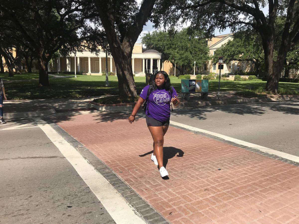 Maliyah Gibbs, an 18-year-old TCU freshman, crosses University Drive at a crosswalk on Sept. 13. She said she regularly encounters masses of students and she thinks about when the best time to cross would be.