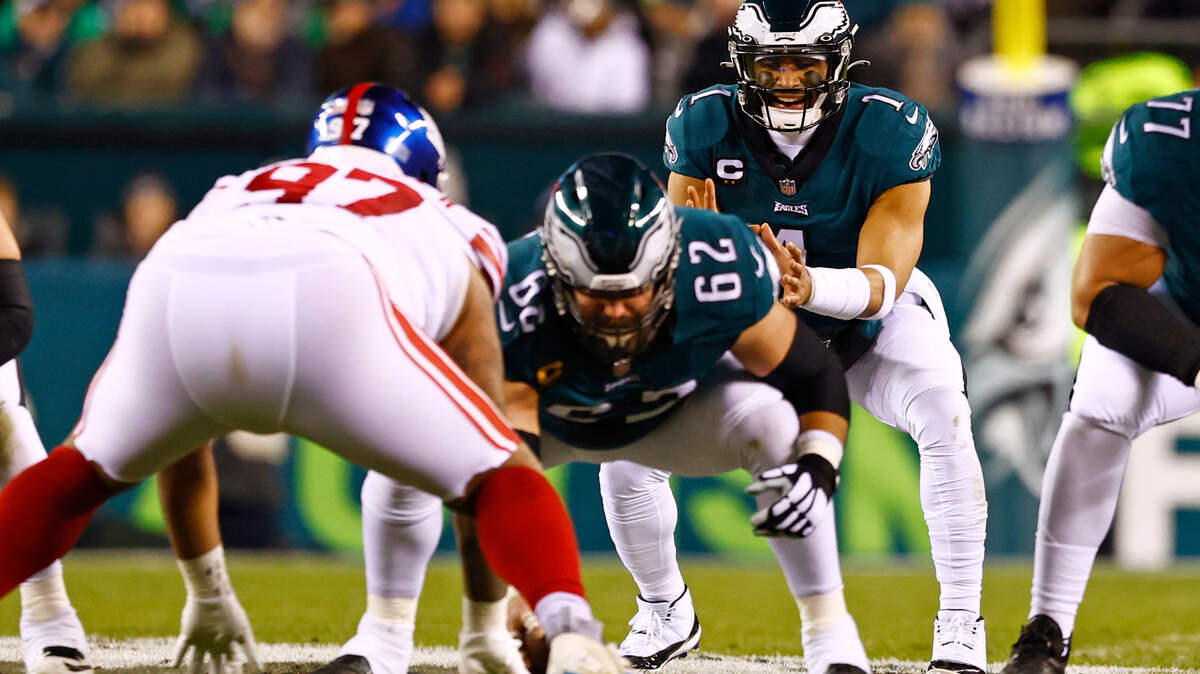 Philadelphia Eagles quarterback Jalen Hurts (1) gets the snap from center Jason Kelce (62) against New York Giants defensive tackle Dexter Lawrence (97) during an NFL divisional round playoff football game on Saturday in Philadelphia. 