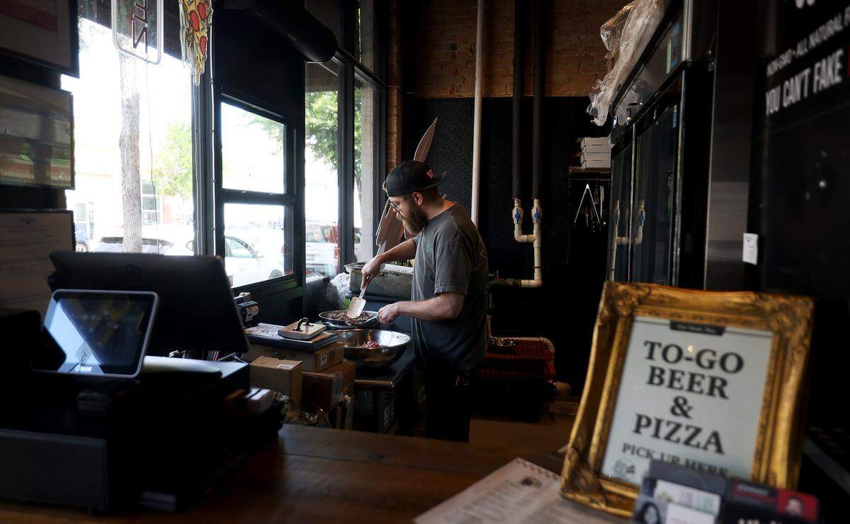 Ben Walter preps ingredients for the new pizza restaurant inside Southside Cellar on Friday, April 10, 2026.