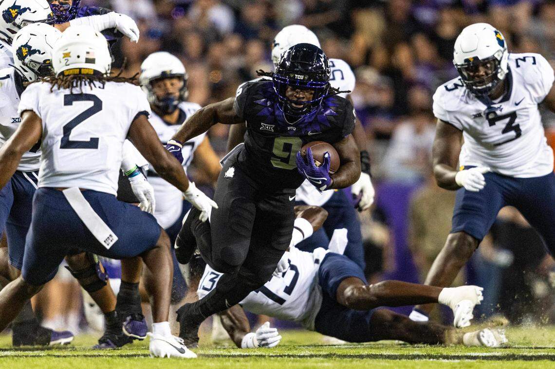 TCU running back Emani Bailey (9) evades West Virginia defenders in the first quarter of a Big XII conference game between the TCU Horned Frogs and the West Virginia Mountaineers at Amon G. Carter Stadium in Fort Worth on Saturday, Sept. 30, 2023.