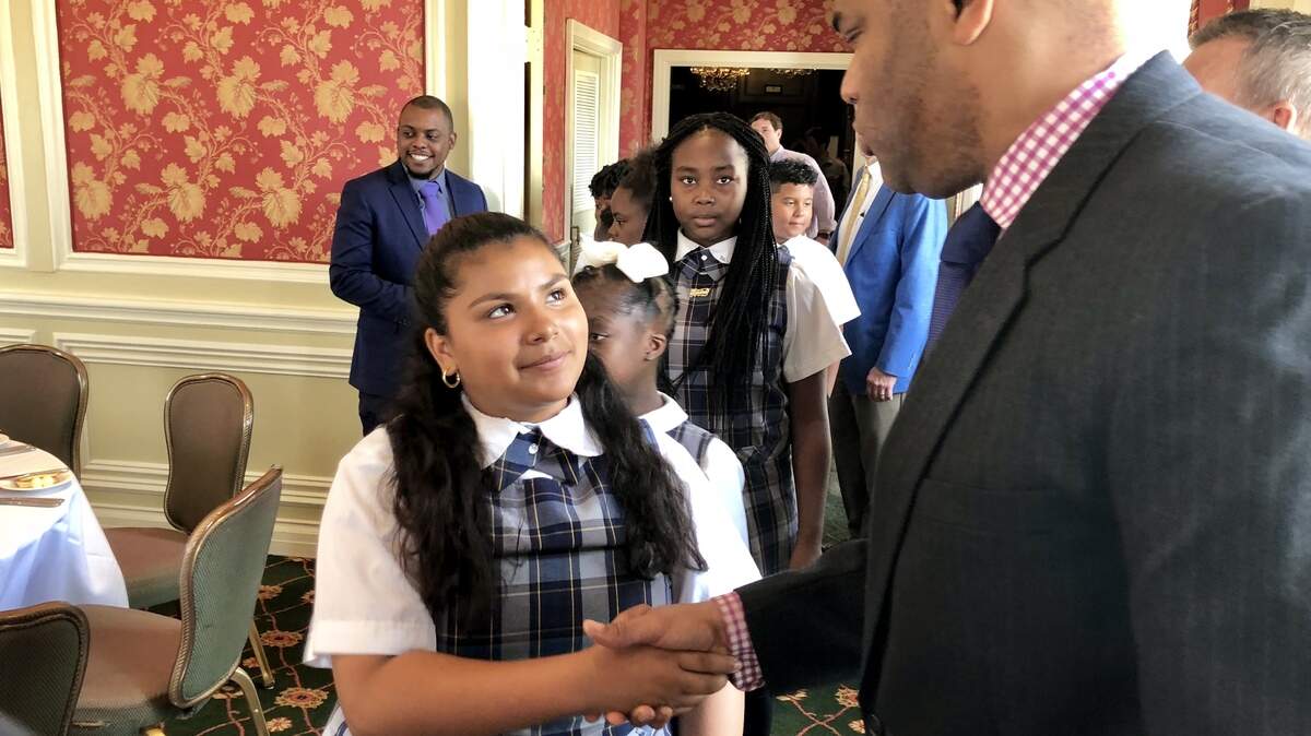 Kayleen Lopez of Rivertree Academy meets U.S. Rep. Marc Veasey as donors host the children at a Fort Worth Club luncheon.