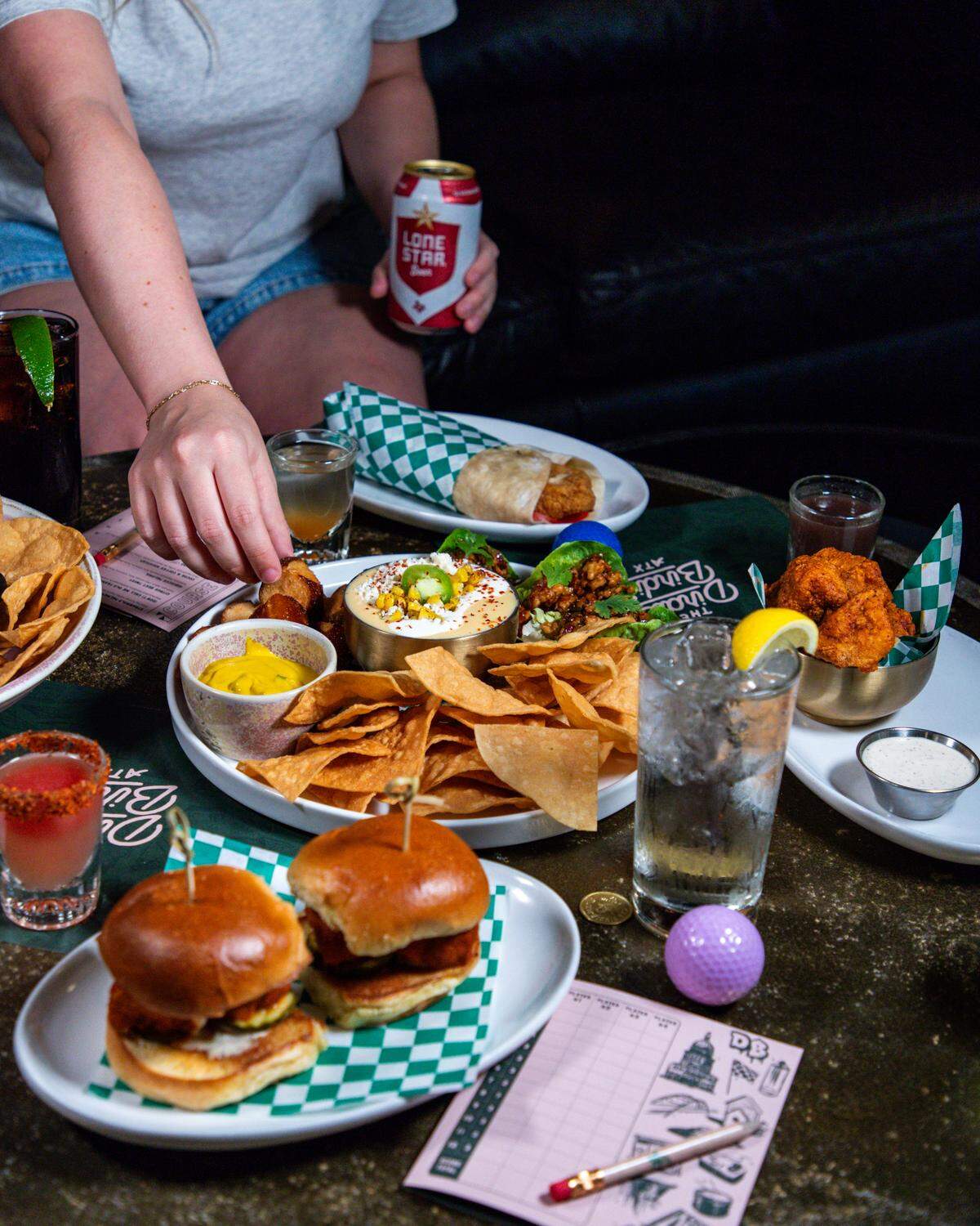 The Nashville hot chicken sliders, street corn queso and chicken snack wrap are some of the offerings at The Dirdie Birdie indoor mini golf course restaurant and bar.