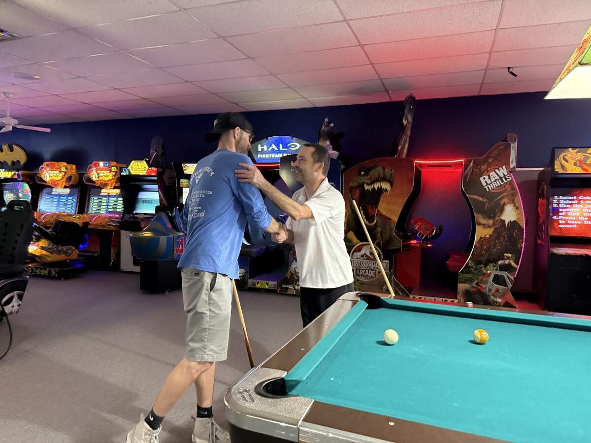 (Left)Richard Bell, the son of Terry Bell and longtime customer (right) Josh Moore shaking hands after a game of pool.