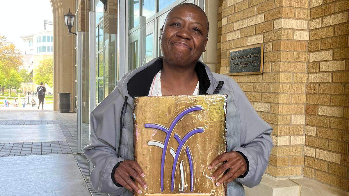 Loriessa Randle holds a plaque honoring her fourth great-grandfather for his work at TCU. The university’s second annual Reconciliation Day hosted a full auditorium of students, faculty, staff and alumni.