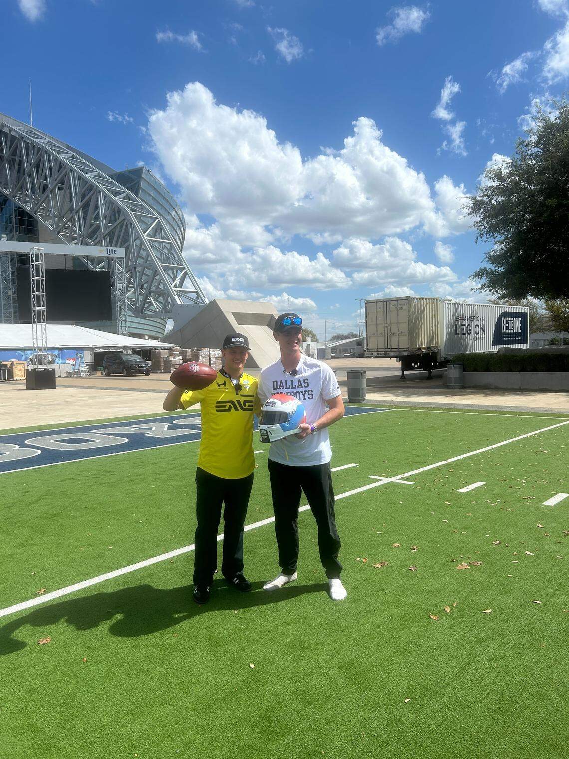Mick Schumacher holding a football (left) and Brandon Aubrey holding a helmet (right) during e joint training promoting the Java House Grand Prix of Arlington .