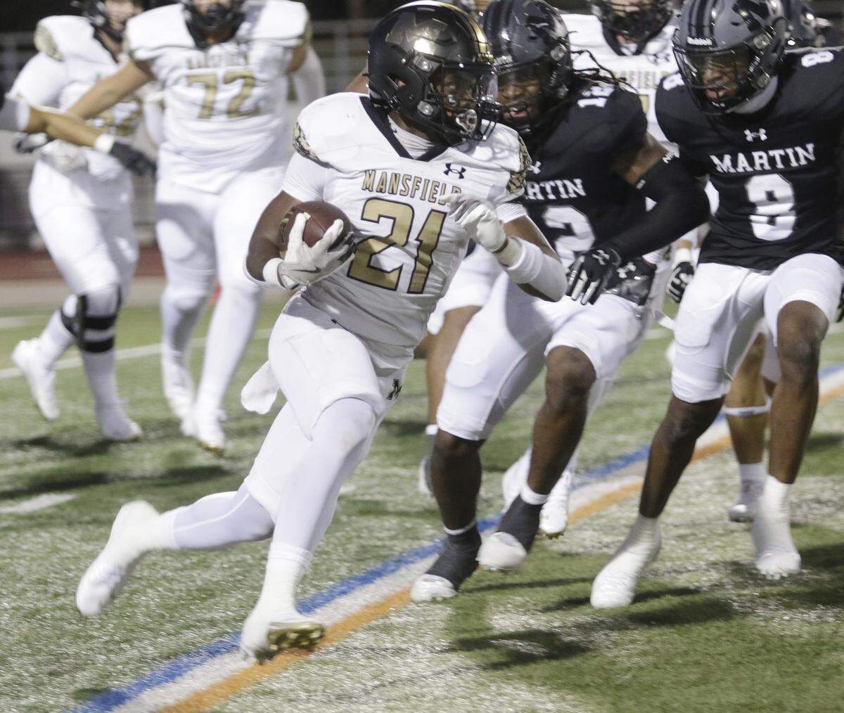 Mansfield’s Raymond Weaver (21) picks up yardage against Arlington Martin during their game on Thursday, September 11, 2025 at Maverick Stadium in Arlington, Texas.